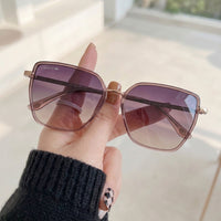 Óculos de Sol Lacoste L6062S Geométrico ou Sextavado Rosé Translúcido e Dourado - na mão